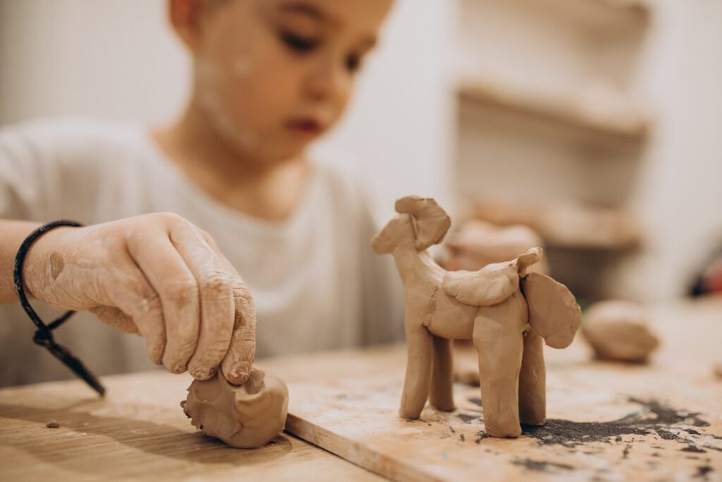 Child making clay animals - Kids Clay club totnes